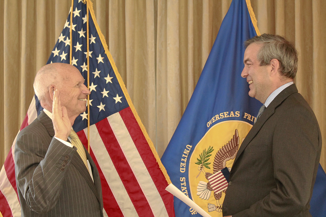 photo, Irving Bailey being sworn in by David Bohigian, while standing in front of the OPIC flag and the U.S. flag, OPIC, Overseas Private Investment Corporation, Board of Directors, development finance, american business investing overseas, public diplomacy, foreign policy, impact investing, world development, emerging markets 