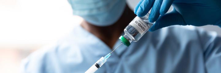 Medical technician draws a dose of COVID vaccine