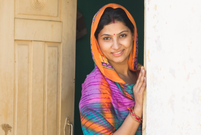 Indian woman standing in the doorway of a home