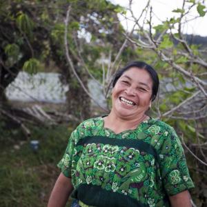 photo, Latina woman wearing green dress smiling, Kiva, DFC, USDFC, OPIC, US International Development Finance Corporation