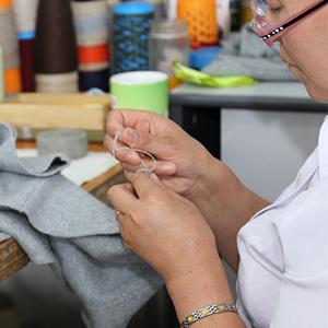 photo, woman sewing, Goyol Cashmere, Mongolia, DFC, US International Development Finance Corporation