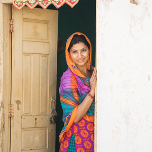 Indian woman standing in a doorway of a home